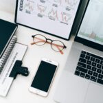 Laptop Beside Eyeglasses and Smartphone