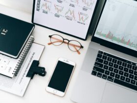 Laptop Beside Eyeglasses and Smartphone